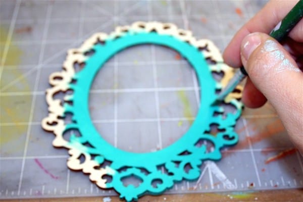 Painting the wood embellishment with aqua craft paint