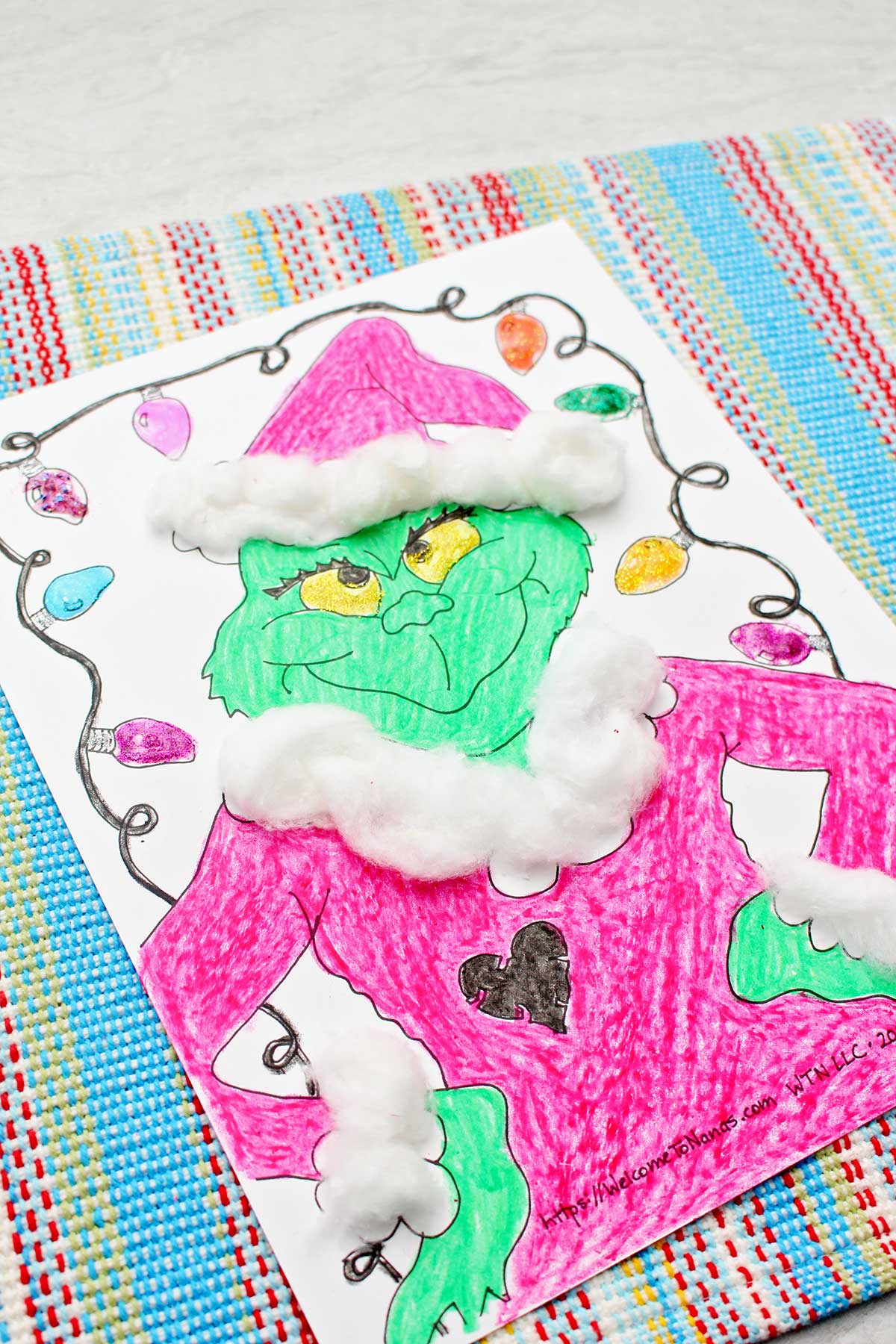 Close up of a completed Grinch coloring page.