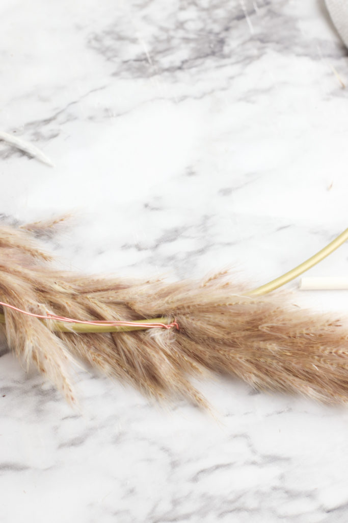 Bending the pampas grass around the hoop wreath.