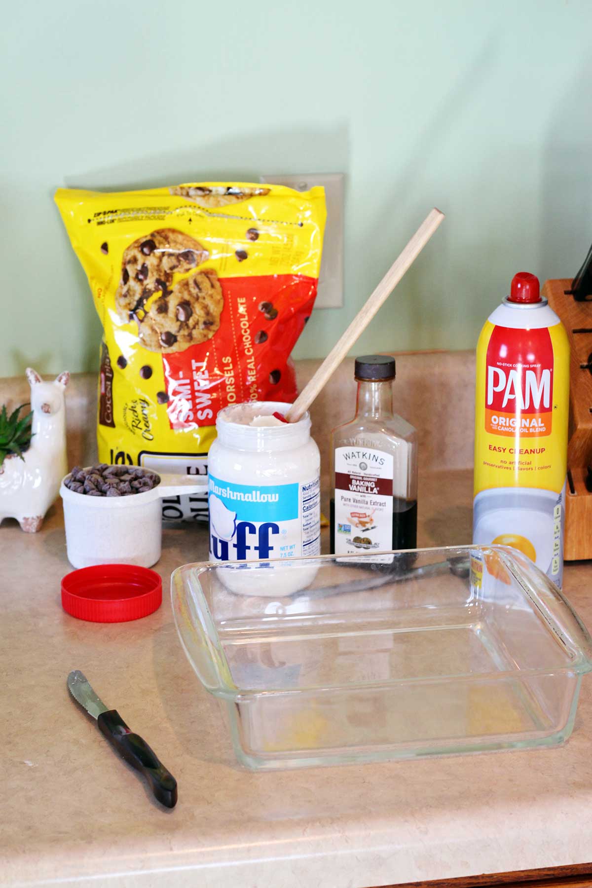 Ingredients for fudge and an 8x8 glass baking pan on a counter.
