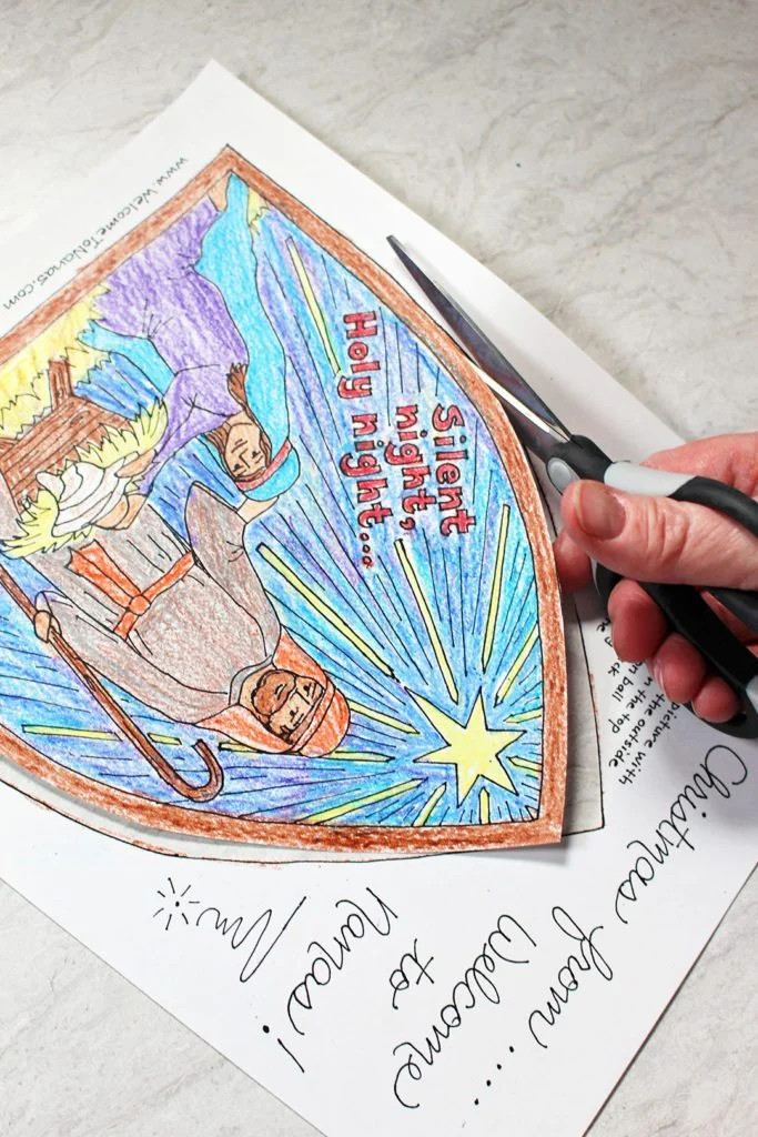 Cutting out the nativity scene coloring page.
