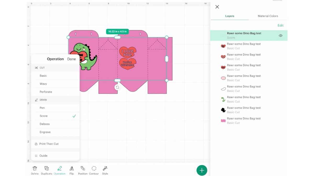 Cricut Design Space screen showing a dinosaur Valentine treat bag with fold lines selected and set to score, plus the layers panel open.