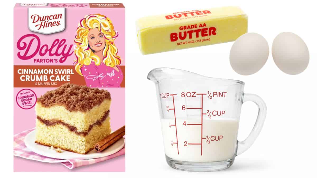 Baking ingredients arranged on a white background, including a cinnamon swirl cake mix box, butter, two eggs, and a glass measuring cup filled with milk.