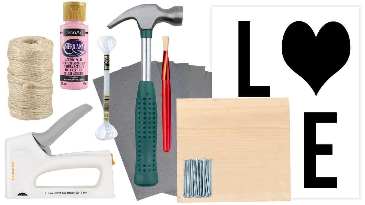 Supplies for a DIY LOVE banner including twine, acrylic paint, hammer, nails, sandpaper, wood board, paintbrush, cotton swabs, hot glue gun, and stencil.