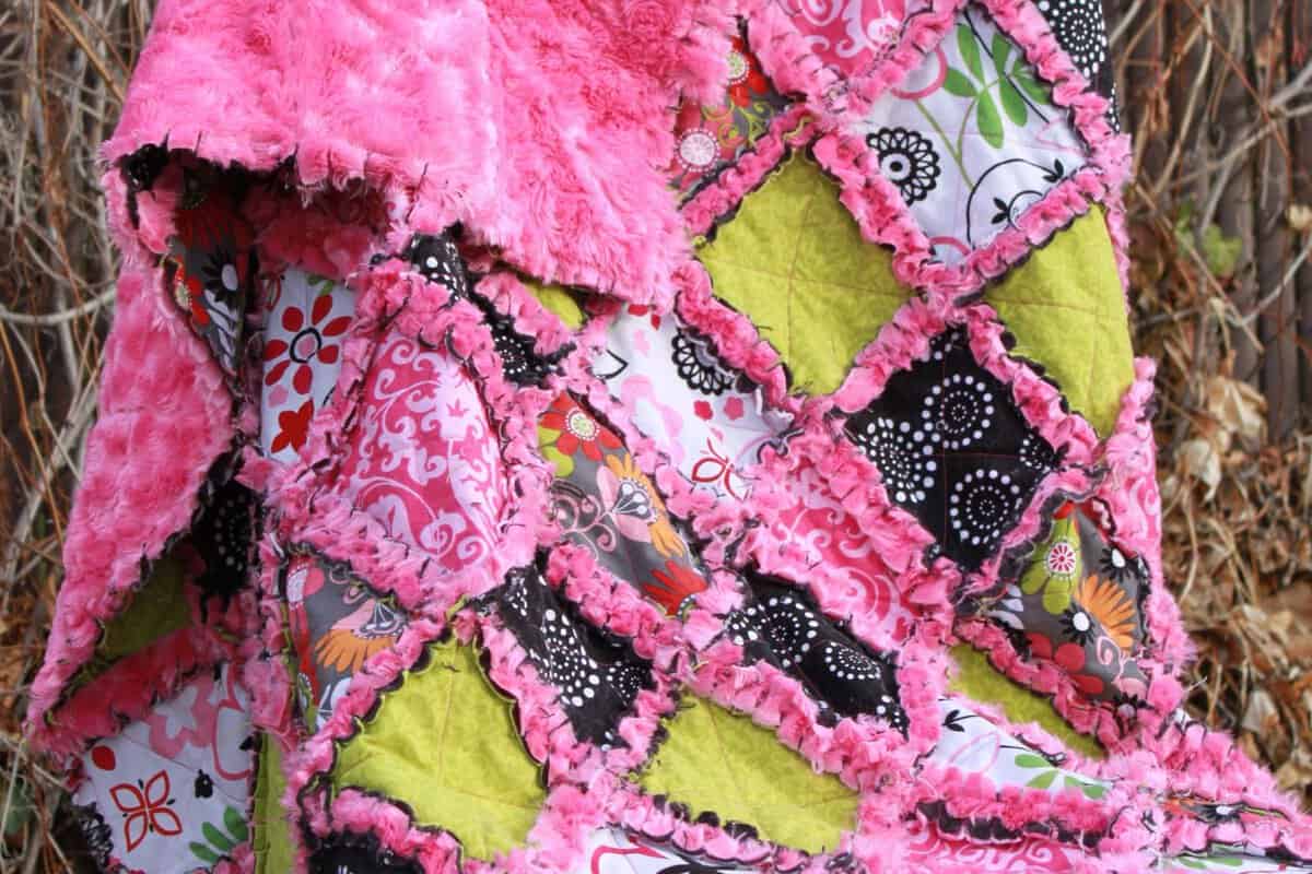 Minky rag quilt displayed on a chair.