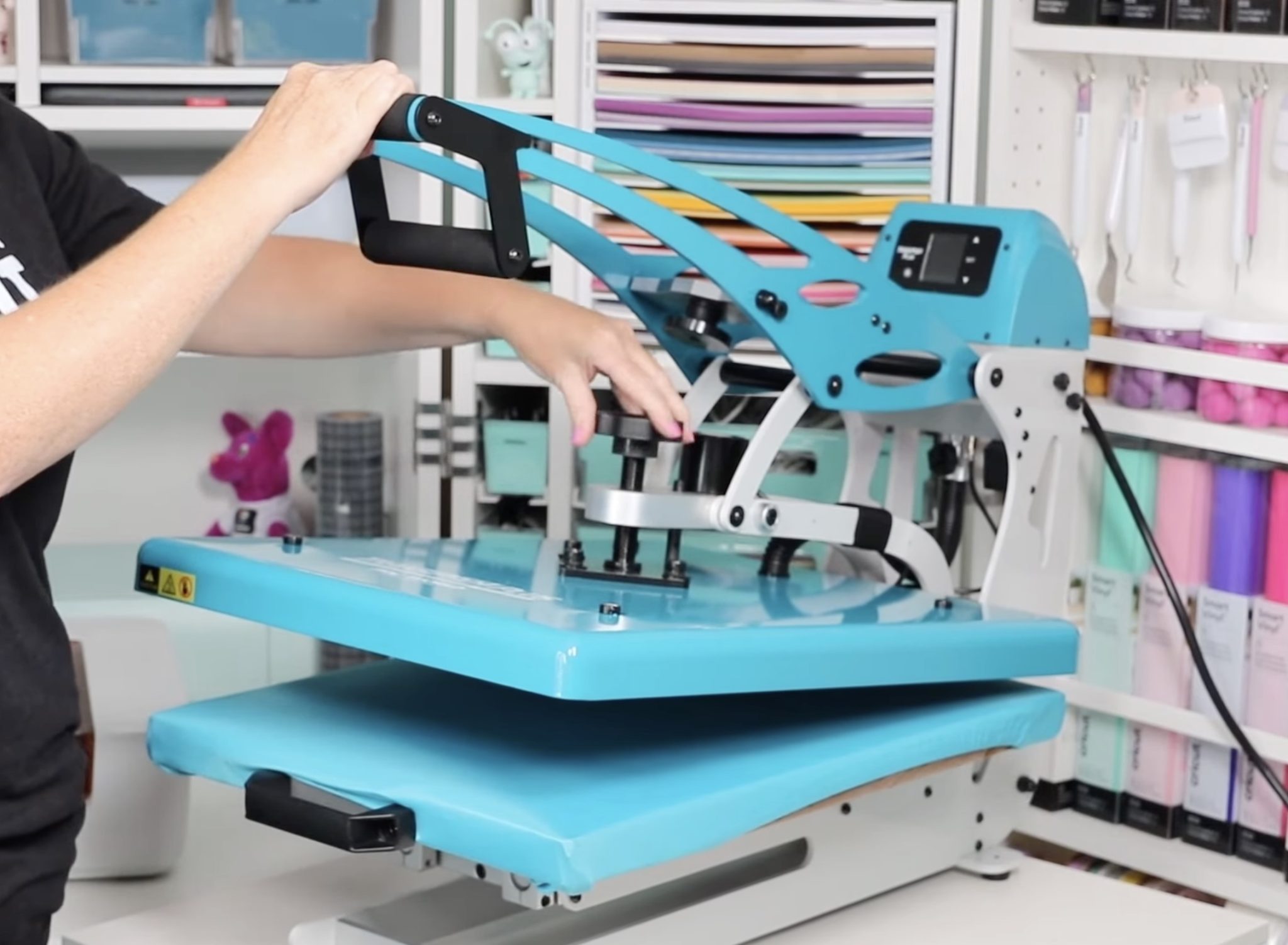 Adjust heat press pressure with knob.