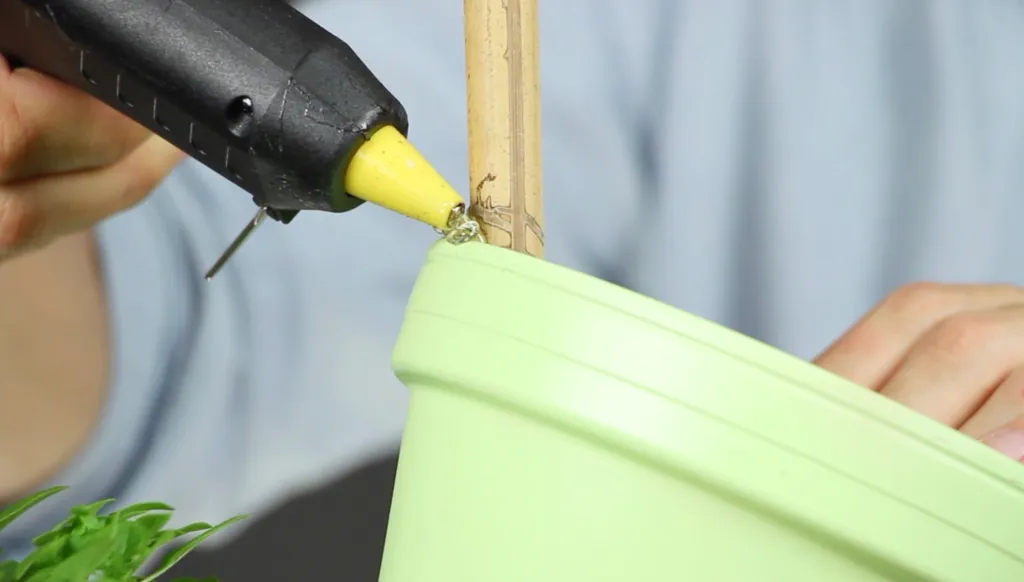 A flower pot tower is secured with hot glue.