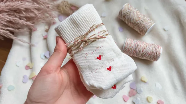 Embroidered white tennis socks with hearts wrapped with ribbon